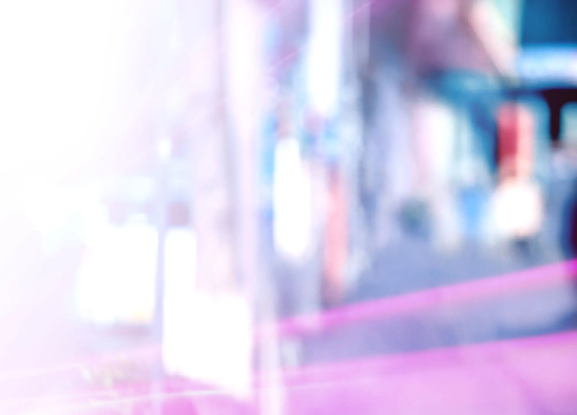 Abstract blur of soft pink, purple, and white light.